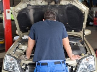 Mechanic Looking Under Hood