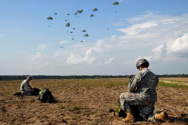 Members of the 75th Ranger Regiment gathers their parachutes after landing on Fryar Drop Zone Aug. 3 as part of a mass tactical airborne operation. More than 1,000 Rangers from all four of the Regiment's battalions participated in the jump, officially kicking off Ranger Rendezvous 2009. (Photo by Sgt. Tony Hawkins, USASOC PAO)